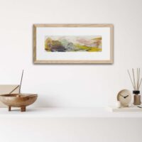 Abstract landscape titled A Primitive World - above a white shelf with wooden ornaments on it