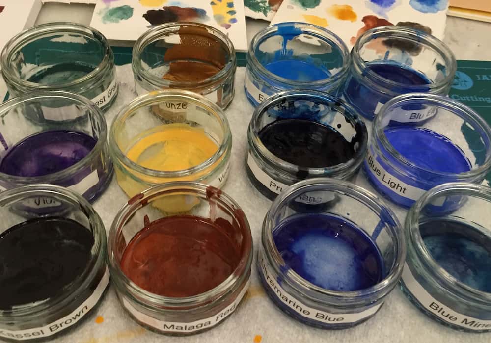 Mixed watercolour paint in containers