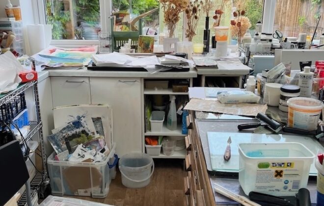 Finding your focus. An artist studio showing art materials spread over surfaces.